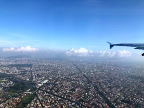 Tail end of airplane flying in the clouds